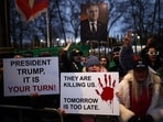 Anti-Iranian regime protesters wave Iranian flags during a gathering outside the Iranian Embassy, central London, on January 12, 2026.(AFP)