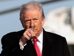 US President Donald Trump gestures, before boarding Air Force One en route to Detroit, Michigan, at Joint Base Andrews, Maryland, on January 13 (REUTERS)
