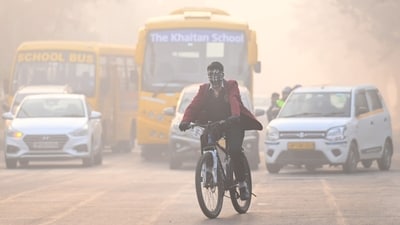 A student covers himself with a muffler as he rides his cycle amid heavy traffic in Noida after Delhi-NCR recorded significantly low temperatures. (Sunil Ghosh/Hindustan Times) A student covers himself with a muffler as he rides his cycle amid heavy traffic in Noida after Delhi-NCR recorded significantly low temperatures. (Sunil Ghosh/Hindustan Times)