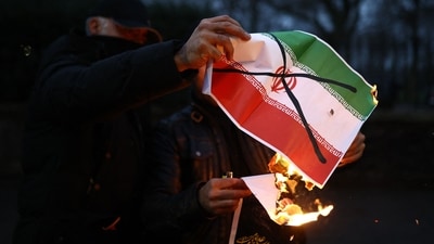 Anti-Iranian regime protesters burn an image of the Iranian flag, during a gathering outside the Iranian Embassy, central London, on January 12, 2026. (AFP) Anti-Iranian regime protesters burn an image of the Iranian flag, during a gathering outside the Iranian Embassy, central London, on January 12, 2026. (AFP)