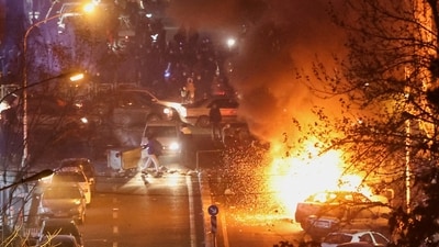 Cars burn in a street during a protest over the collapse of the currency's value, in Tehran, Iran, January 8, 2026. Stringer/WANA (West Asia News Agency) (via REUTERS)