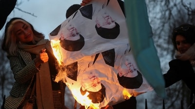 Demonstrators burn pictures of Iran's Supreme Leader Ayatollah Ali Khamenei outside the Iranian embassy during a rally in support of nationwide protests in Iran, in London, Britain, January 12, 2026.&nbsp; (REUTERS)