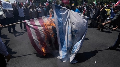  Iranian protestors burn representations of the Israeli and U.S. flags during a protest to condemn Israeli attacks on multiple cities across Iran, after the Friday prayers ceremony in Tehran, Iran, Friday, June 20, 2025 (AP) Iranian protestors burn representations of the Israeli and U.S. flags during a protest to condemn Israeli attacks on multiple cities across Iran, after the Friday prayers ceremony in Tehran, Iran, Friday, June 20, 2025 (AP)