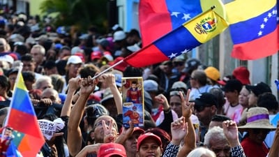 A demonstrator holds a toy of the caped superhero named "Super-Bigote" (Super-Mustache) during a rally in support of ousted Venezuela's President Nicolas Maduro in Valencia, Carabobo state, Venezuela (AFP) A demonstrator holds a toy of the caped superhero named "Super-Bigote" (Super-Mustache) during a rally in support of ousted Venezuela's President Nicolas Maduro in Valencia, Carabobo state, Venezuela (AFP)