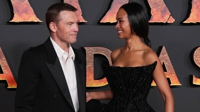 Sam Worthington, left, and Zoe Saldana attend the European premiere of the film "Avatar: Fire and Ash", in Paris, Friday, Dec. 5, 2025. (AP Photo/Christohe Ena) (AP)
