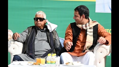 Janshakti Janta Dal party president and former RJD MLA Tej Pratap Yadav with his father and RJD Chief Lalu Prasad during 'Dahi-Chura Bhoj' on the occasion of Makar Sankranti festival at his residence in Patna, Bihar, India, Wednesday,14, 2026.(Photo by / Hindustan Times) (Santosh Kumar/HT) Janshakti Janta Dal party president and former RJD MLA Tej Pratap Yadav with his father and RJD Chief Lalu Prasad during 'Dahi-Chura Bhoj' on the occasion of Makar Sankranti festival at his residence in Patna, Bihar, India, Wednesday,14, 2026.(Photo by / Hindustan Times) (Santosh Kumar/HT)