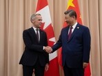 Canadian Prime Minister Mark Carney, left, shakes hands with Chinese President Xi Jinping.