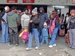 Commuters waiting for buses in Ludhiana on Wednesday. (Manish/HT)