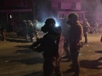 Federal law enforcement agents and police officers in riot gear walk amid smoke from crowd-control devices after protests broke out following the shooting of a Venezuelan man by a Immigration and Customs Enforcement (ICE) agent in Minneapolis, Minnesota, on January 14, 2026. (Photo by Octavio JONES / AFP)