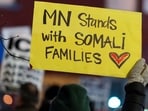 Jake Lang's March Against Minnesota Fraud is planned for January 17 at 1 p.m. from Minneapolis City Hall. A protestor hold banner in support of Somali Immigrants. 