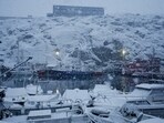 Snow-covered boats docked at the harbor in Nuuk, Greenland's capital.