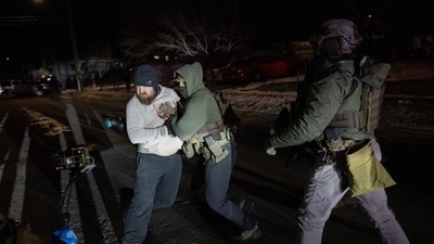 Federal officers confront a resident in the aftermath of a shooting in Minneapolis, Minnesota, on Wednesday, January 14, 2026. Photographer: Victor J. Blue/Bloomberg (Bloomberg)