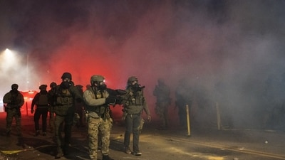 Federal officers fire tear gas during clashes with residents after a shooting in Minneapolis. Photographer: Victor J. Blue/Bloomberg (Bloomberg)