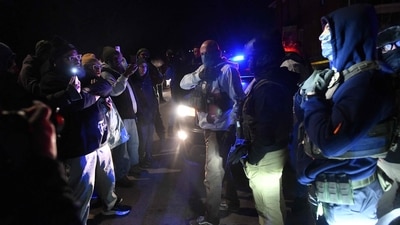 Federal immigration agents clad in gear squared off with demonstrators as protests erupted after an ICE officer shot a Venezuelan man during an enforcement operation in Minneapolis, Minnesota, on January 14, 2026. &nbsp;(Photo by Octavio JONES / AFP) (AFP)