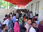 People queue up to vote outside a polling station at BMC school in the Dharavi area during the BMC general elections 2025-2026 in Mumbai, India. Jan 15,2026.