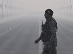 A Central Reserve Police Force (CRPF) member at Kartavya Path amid smog on a cold winter morning, in New Delhi.