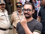 Aamir Khan shows his ink-marked finger after casting his vote in the BMC Election, in Mumbai on Thursday. (ANI Video Grab)