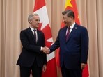 Canadian Prime Minister Mark Carney, left, shakes hands with Chinese President Xi Jinping.