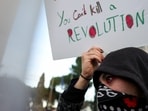 A woman holds a placard during a rally in support of Iran's protests in Italy.
