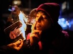 The gesture has jumped from the virtual world to the real one, with opponents of the regime lighting cigarettes on photos of the ayatollah from Israel to Germany and Switzerland to the United States.