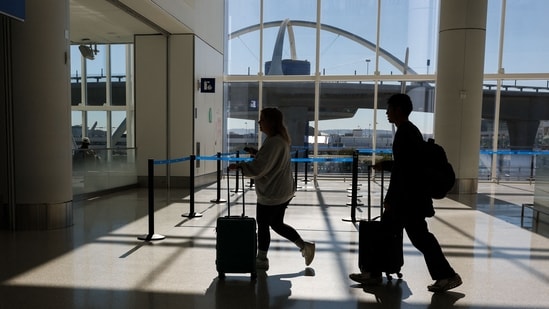 Passengers walk to a Transportation Security Administration (TSA) security checkpoint while traveling at Los Angeles International Airport (LAX). (AFP)