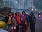 New Delhi: People and School students seen out during a cold winter morning near Pandav Nagar in New Delhi. (Photo by RAJ K RAJ / Hindustan Times)