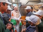 PM Modi shares smiles and shakes hands with school students aboard the new Vande Bharat sleeper train.(PMO/PTI)