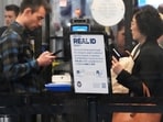 A Real ID sign is displayed as Travelers wait to go through the security checkpoint at O'Hare International Airport in Chicago A Real ID sign is displayed as Travelers wait to go through the security checkpoint at O'Hare International Airport in Chicago