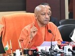 Uttar Pradesh chief minister Yogi Adityanath talking to reporters in Varanasi on January 17. (HT photo)