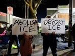 Anti-ICE activists display signs during a protest at the US Immigration and Customs Enforcement (ICE) building in Portland.