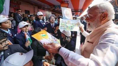School students present PM Modi with paintings in West Bengal's Malda during the inaugurating of Vande Bharat sleeper train. (DPR PMO/ANI) School students present PM Modi with paintings in West Bengal's Malda during the inaugurating of Vande Bharat sleeper train. (DPR PMO/ANI)