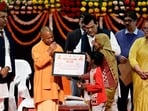 CM Yogi Adityanath transferred the first instalment of the Pradhan Mantri Awas Yojana (Urban) 2.0 to the bank accounts of 2,09,421 beneficiaries in the state. (HT)