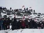 People wave Greenlandic flags as they take part in a demonstration that gathered almost a third of the city population to protest against the US President's plans to take Greenland, on January 17