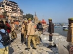 Police personnel stand guard at Manikarnika Ghat after people protested over alleged demolition of idols at the ghat as part of the ongoing renovation work, in Varanasi, Tuesday, Jan. 13, 2026. 