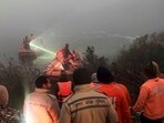 Police and State Disaster Response Force (SDRF) personnel conduct a search operation after a 27-year-old software engineer died on Saturday after his car went out of control and fell into a 20-feet-deep water-filled pit that was dug for the basement of an under-construction building, in Noida.