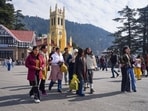 Tourists take a stroll in cloudy weather at Ridge, in Shimla on Sunday. (ANI)