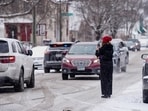 A person records with their phone while ICE agents and other law enforcement officers conduct an immigration raid at a home in St. Paul, Minnesota, U.S., January 18, 2026. (REUTERS/Leah Millis)