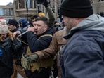 MINNEAPOLIS, MINNESOTA - JANUARY 17: Right wing influencer Jake Lang is confronted by protesters at a rally near city hall on January 17, 2026 in Minneapolis, Minnesota. (Photo by Jim Vondruska / GETTY IMAGES NORTH AMERICA / Getty Images via AFP)