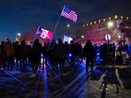 Protesters hold flags during an anti-US Immigration and Customs Enforcement (ICE) protest in front of the Bishop Henry Whipple Federal Building in Minneapolis, Minnesota on January 17, 2026. (Photo by ROBERTO SCHMIDT / AFP)