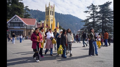 Tourists take a stroll in cloudy weather at Ridge, in Shimla on Sunday. (ANI) Tourists take a stroll in cloudy weather at Ridge, in Shimla on Sunday. (ANI)
