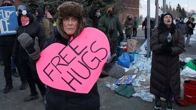 A demonstrator displays a sign, in front of the Bishop Henry Whipple Federal Building, during a protest more than a week after a U.S. Immigration and Customs Enforcement (ICE) agent fatally shot Renee Nicole Good, in Minneapolis, Minnesota, U.S., January 17, 2026. (REUTERS/Seth Herald) (REUTERS)