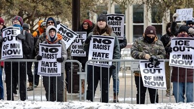 MINNEAPOLIS, MINNESOTA - JANUARY 17: Anti-ICE protesters stand near City Hall with signs on January 17, 2026 in Minneapolis, Minnesota. Protesters gathered after federal agents continued an imigration enforcement dubbed "Operation Metro Surge". (Photo by Jim Vondruska / GETTY IMAGES NORTH AMERICA / Getty Images via AFP) (Getty Images via AFP) MINNEAPOLIS, MINNESOTA - JANUARY 17: Anti-ICE protesters stand near City Hall with signs on January 17, 2026 in Minneapolis, Minnesota. Protesters gathered after federal agents continued an imigration enforcement dubbed "Operation Metro Surge". (Photo by Jim Vondruska / GETTY IMAGES NORTH AMERICA / Getty Images via AFP) (Getty Images via AFP)