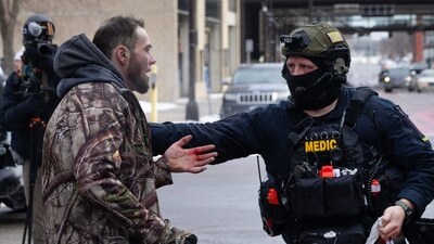 A medic traveling with Sheriff's police rescues a suspected white nationalist demonstrator who was injured after clashing with immigrant rights protestors on January 17, 2026 in Minneapolis, Minnesota. (Photo by SCOTT OLSON / GETTY IMAGES NORTH AMERICA / Getty Images via AFP) (Getty Images via AFP) A medic traveling with Sheriff's police rescues a suspected white nationalist demonstrator who was injured after clashing with immigrant rights protestors on January 17, 2026 in Minneapolis, Minnesota. (Photo by SCOTT OLSON / GETTY IMAGES NORTH AMERICA / Getty Images via AFP) (Getty Images via AFP)