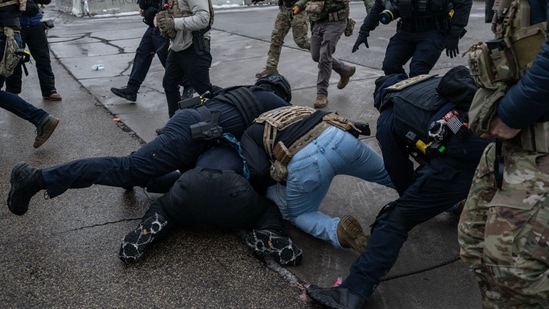 Federal law enforcement officers detain a demonstrator during a protest outside the Bishop Henry Whipple Federal Building in St. Paul, Minnesota, US, on Saturday, Jan. 17, 2026. (Photographer: Victor J. Blue/Bloomberg)(Bloomberg)