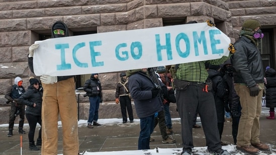 Demonstrators hold a sign while protesting against the Immigration and Customs Enforcement (ICE) deployment in Minneapolis, Minnesota, US, on Saturday, Jan. 17, 2026. (Photographer: Victor J. Blue/Bloomberg)(Bloomberg)