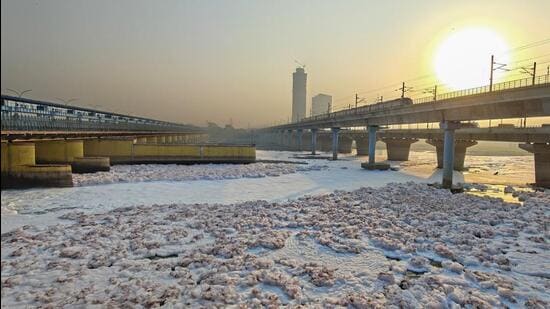 Soap-like surfactant molecules in the polluted waters turn into froth as a result of falling from a height at the nearby Okhla barrage. (HT Archive)