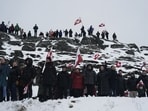 People wave Greenlandic flags as they take part in a demonstration that gathered almost a third of the city population to protest against the US President's plans to take Greenland, on January 17