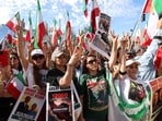 People hold signs as they march in solidarity with the people of Iran in Los Angeles, California, U.S. January 18, 2026. REUTERS/Jill Connelly