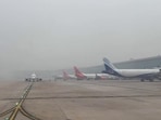 Planes seen parked at IGI airport in Delhi amid dense smog. (ANI)