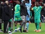 Senegal's Idrissa Gueye gestures to his teammates to leave the pitch after a penalty is awarded to Morocco.